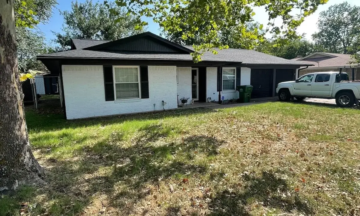 Professional roofing crew working on a residential roof in Hornell